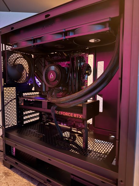 Gaming-PC-Gehäuse mit RGB-Beleuchtung und Flüssigkeitskühlung, sichtbare Hardwarekomponenten.